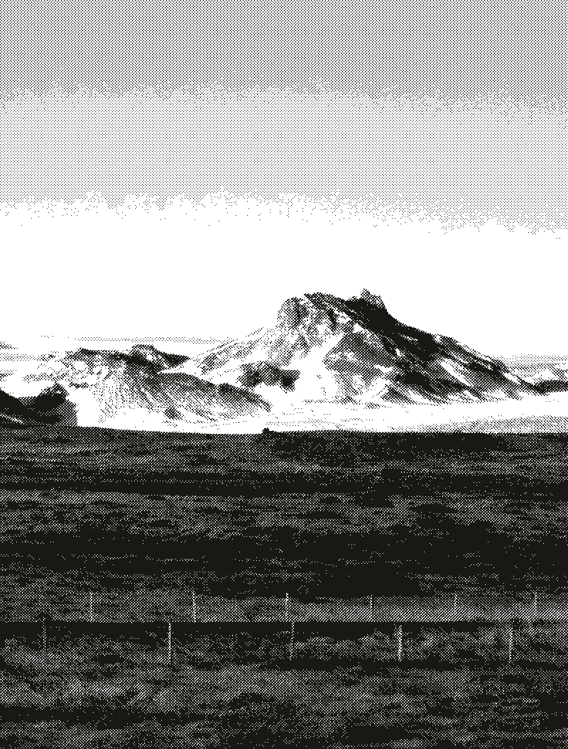 A snow-covered mountain range across an open plain